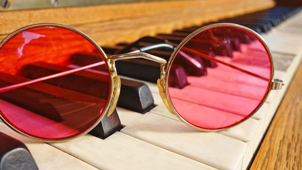 Round-framed glasses on a piano